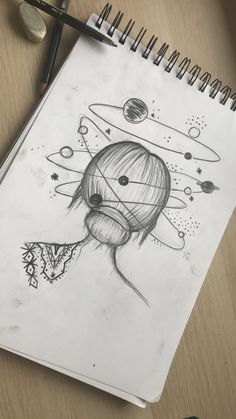 a pencil drawing of a girl with planets and stars in the background on a notepad