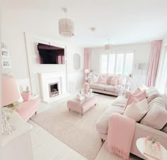 a living room filled with furniture and a flat screen tv mounted on the wall above a fireplace