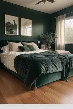 a bedroom with dark green walls and wooden floors