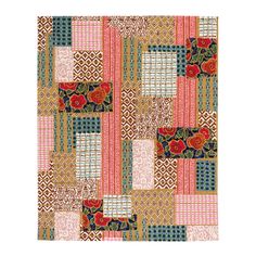 a patchwork quilt with different colors and designs on the fabric, including red flowers