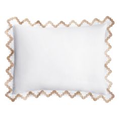 a white pillow with scalloped edges