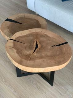 two wooden tables sitting on top of a hard wood floor next to a blue couch