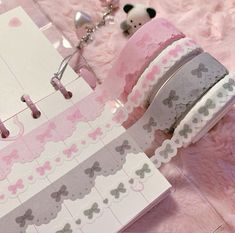 a pink and gray ribbon with bows on it