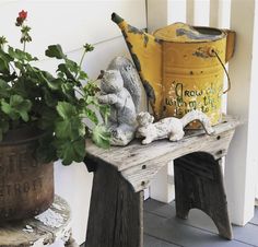 a wooden bench sitting next to a potted plant on top of a wooden table