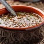 the bowl is full of soup with a spoon sticking out of it's top