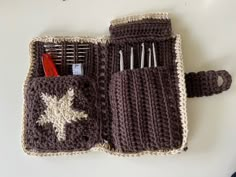 a crocheted bag with scissors and combs in it