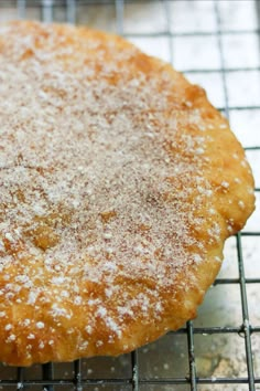 a powdered sugar covered pastry cooling on a wire rack