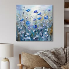 a painting on the wall of a living room with blue and white flowers in it