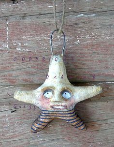 a ceramic starfish hanging on a wooden wall