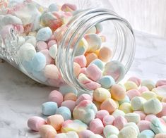 a jar filled with marshmallows sitting on top of a table