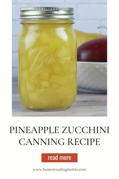 a mason jar filled with pineapple zucchini canning recipe next to a bowl of apples