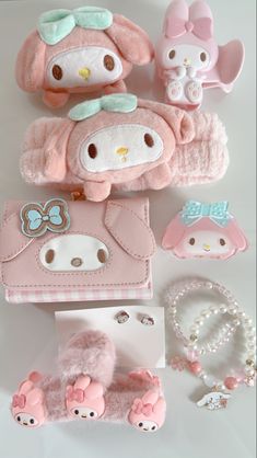 hello kitty doll and accessories laid out on a white surface, including a pink purse