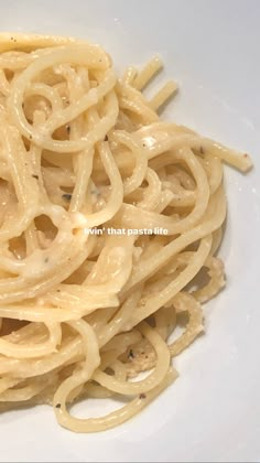 some noodles are on a white plate and is ready to be eaten by someone else