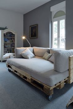 a couch made out of wooden pallets in a living room