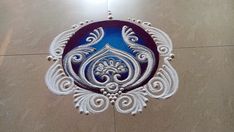 a decorative blue and white wall hanging on the side of a tiled floor in a room