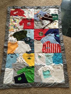 a quilt made to look like it has many different colored shirts on it and is laying on the floor