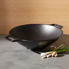 a black bowl sitting on top of a counter next to garlic