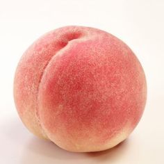 a close up of a peach on a white background with no image in the top right corner