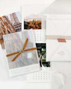 a calendar with a ribbon tied around it on top of a table next to other items