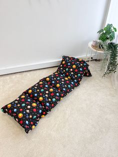 a small child's sleeping bag on the floor in front of a white wall