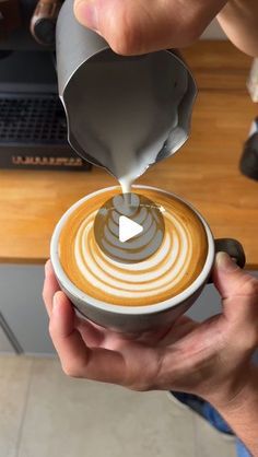 someone is pouring something into a cup that has been made in the shape of a circle