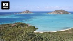 an island surrounded by blue water and trees