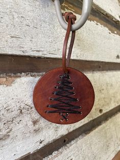 a leather ornament hanging on the side of a building with chains attached to it