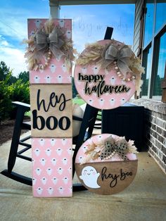 two wooden signs that say happy halloween and hey boo