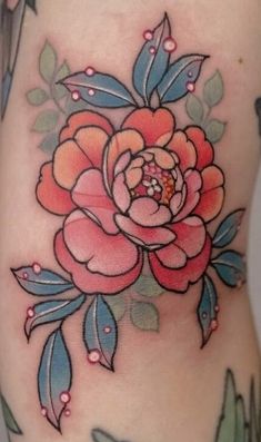 a woman's stomach with a rose tattoo on it