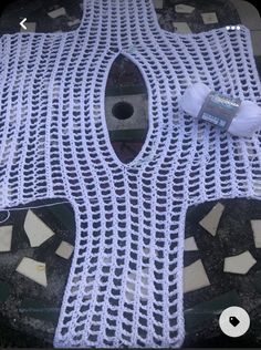 a white crocheted tablecloth with holes in the middle