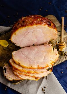 sliced ham sitting on top of a wooden cutting board