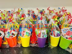 several buckets filled with school supplies on a table