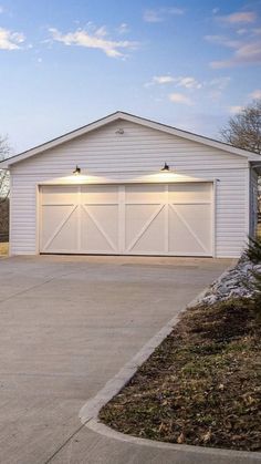 a white garage with two lights on it