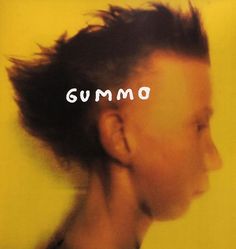 a woman's head with the word gummo written in white on top of it