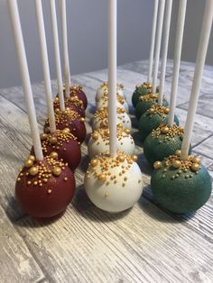 there are many cake pops with gold sprinkles on them