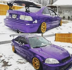 purple car with yellow rims parked in the snow next to a wooden fence and house