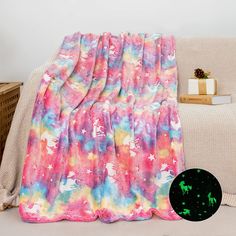 a colorful blanket sitting on top of a couch