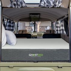 the bed in the back of an rv is made to look like it has been converted into a camper