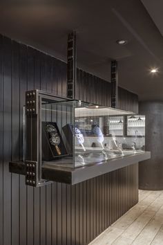 a kitchen with black walls and stainless steel counter tops that has an oven in the middle