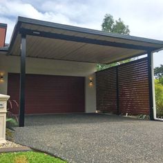 a house with a covered driveway in front of it and two garages on the other side