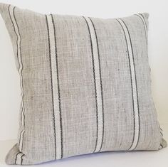 a black and white striped pillow sitting on top of a table