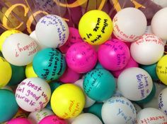 a bunch of colorful balls with writing on them