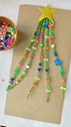 a paper plate with beads and a star on it next to a bowl of candy