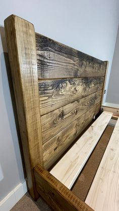 a bed frame made out of wooden planks