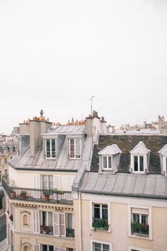 an image of rooftops in the city with windows and balconies on them