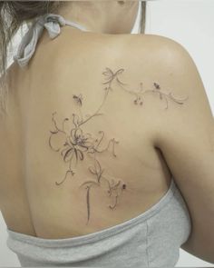 a woman with a tattoo on her back