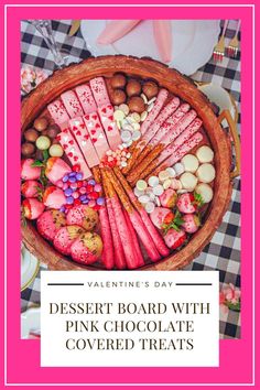 valentine's day dessert board with pink chocolate covered treats in a wooden bowl on a checkered tablecloth