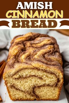 cinnamon bread on a white plate with cinnamon sticks in the background and text overlay that reads, amish cinnamon bread