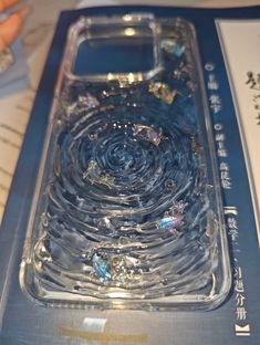 the case is made out of glass and has lots of small jewels on it,