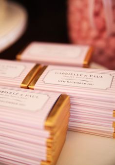 pink and gold business cards stacked on top of each other